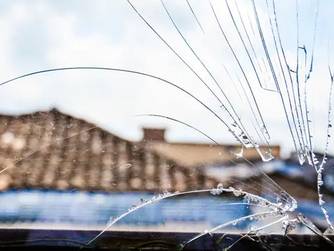 Long cracks running across a windshield to its edge