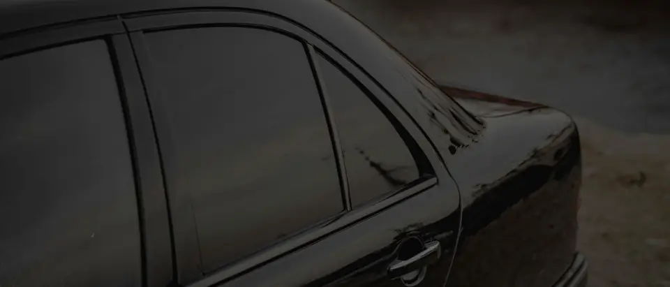 The side windows of a black sedan